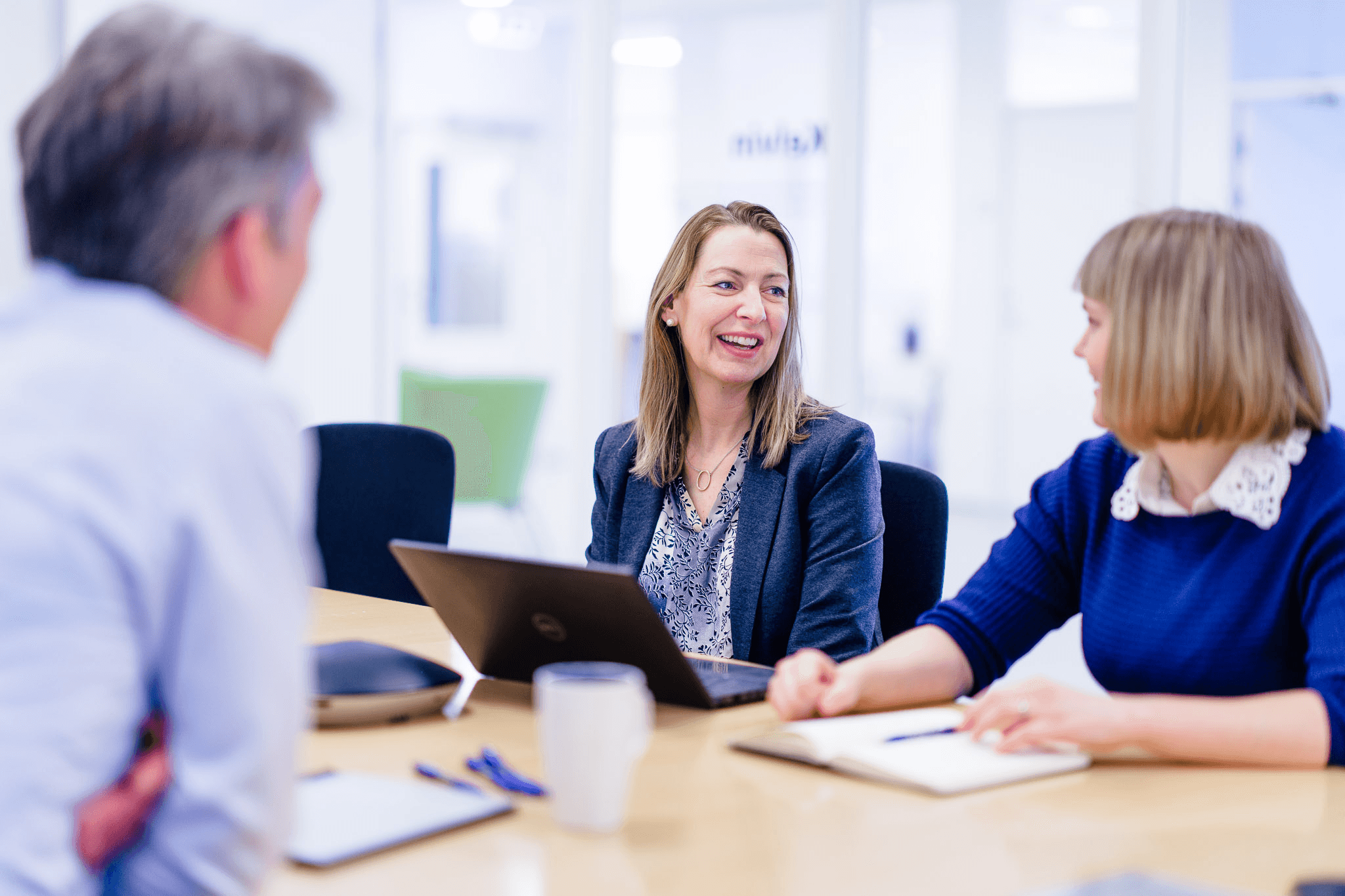Woman in a meeting with two co-workers