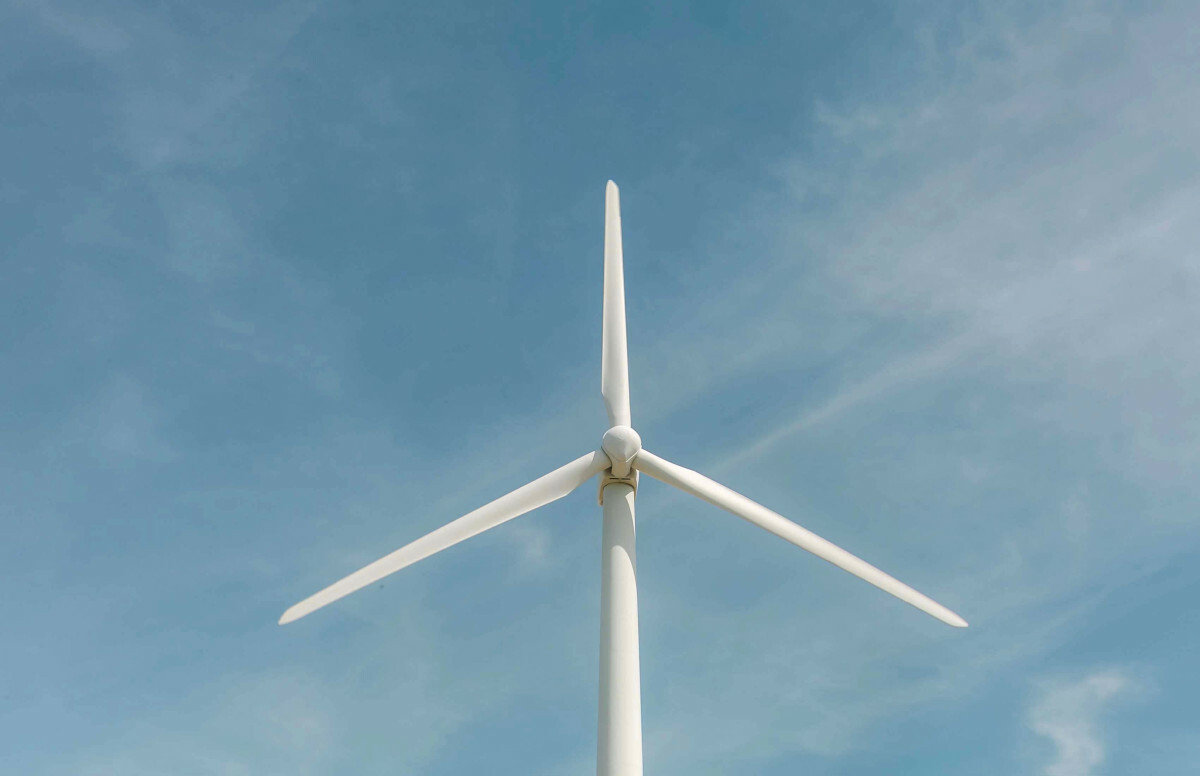 Wind turbine on sky background