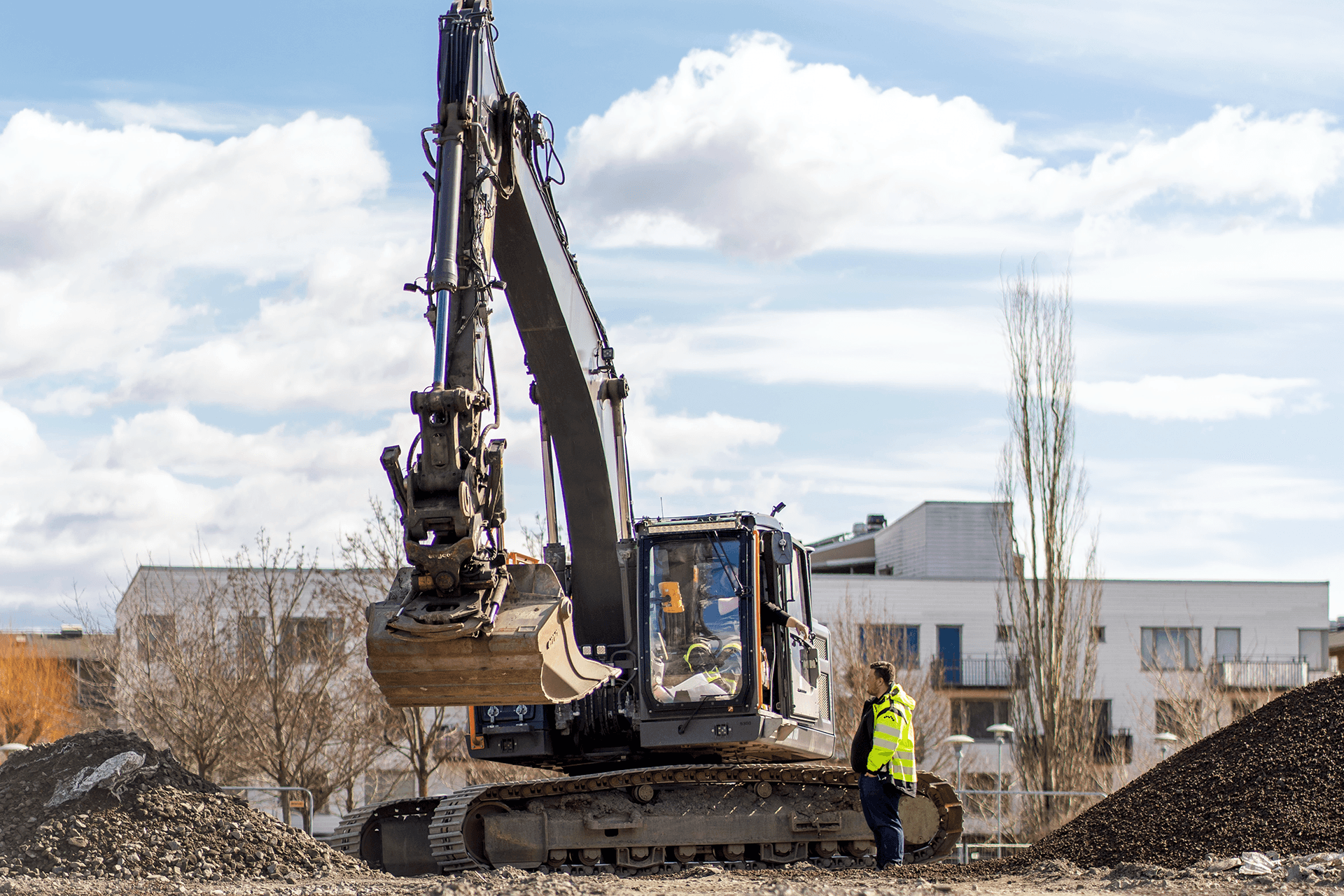 Image of a Excavator-and-two-men-working to represent Volue Excavation Pit
