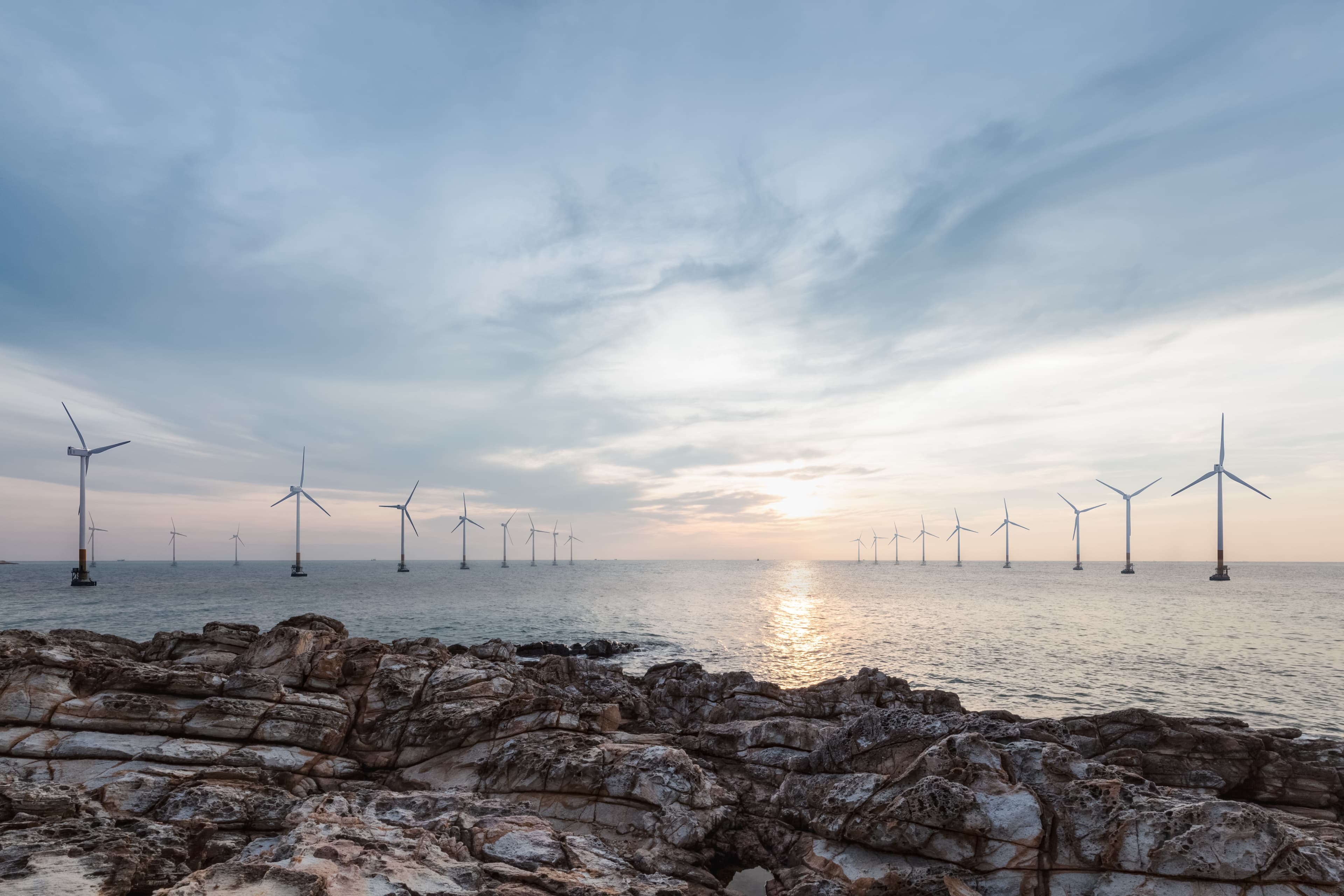 Two lines of energy windmills at the sea