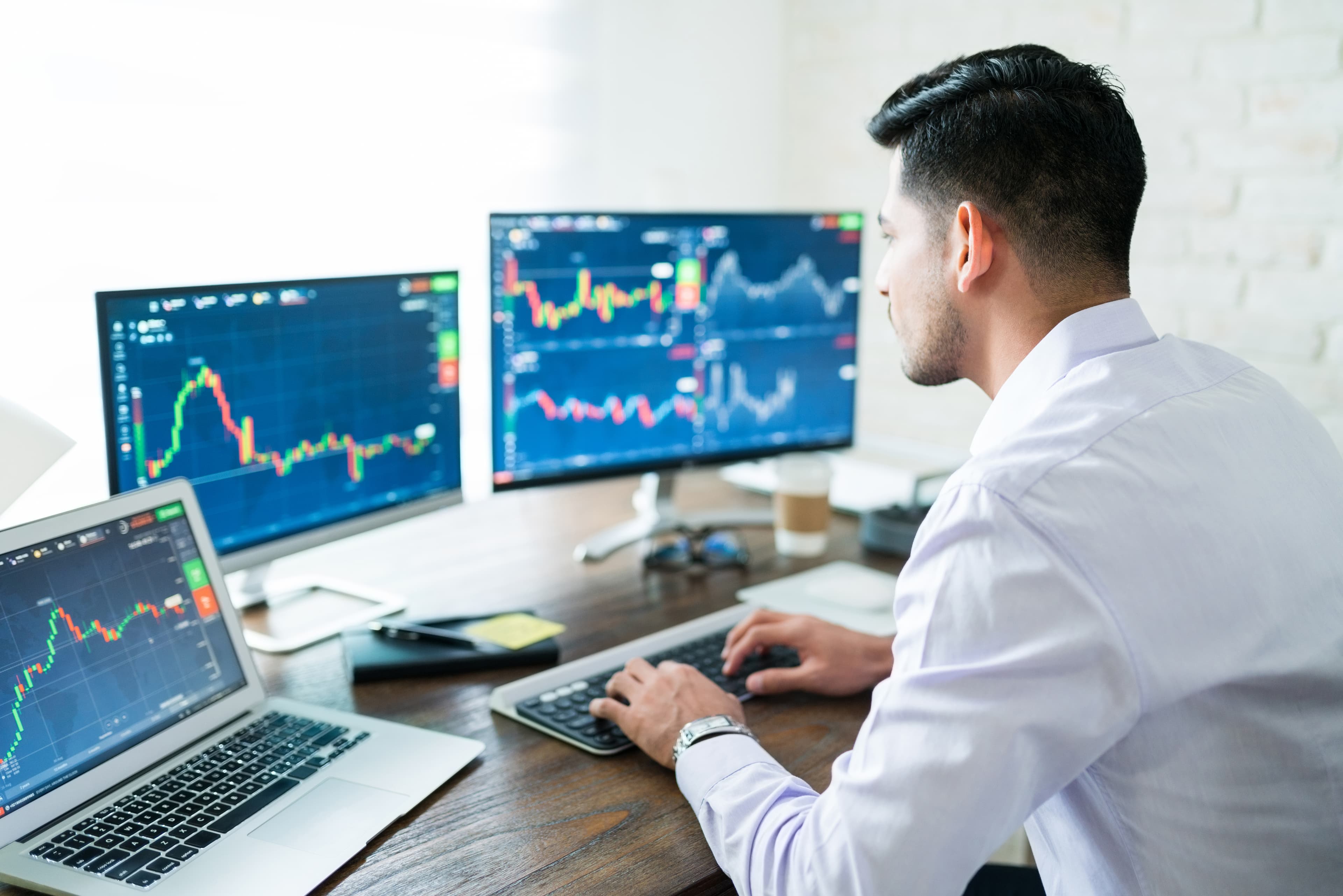 Man in front of computer doing technical analysis