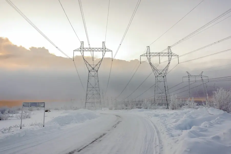 Power grid image with pylons in the snow